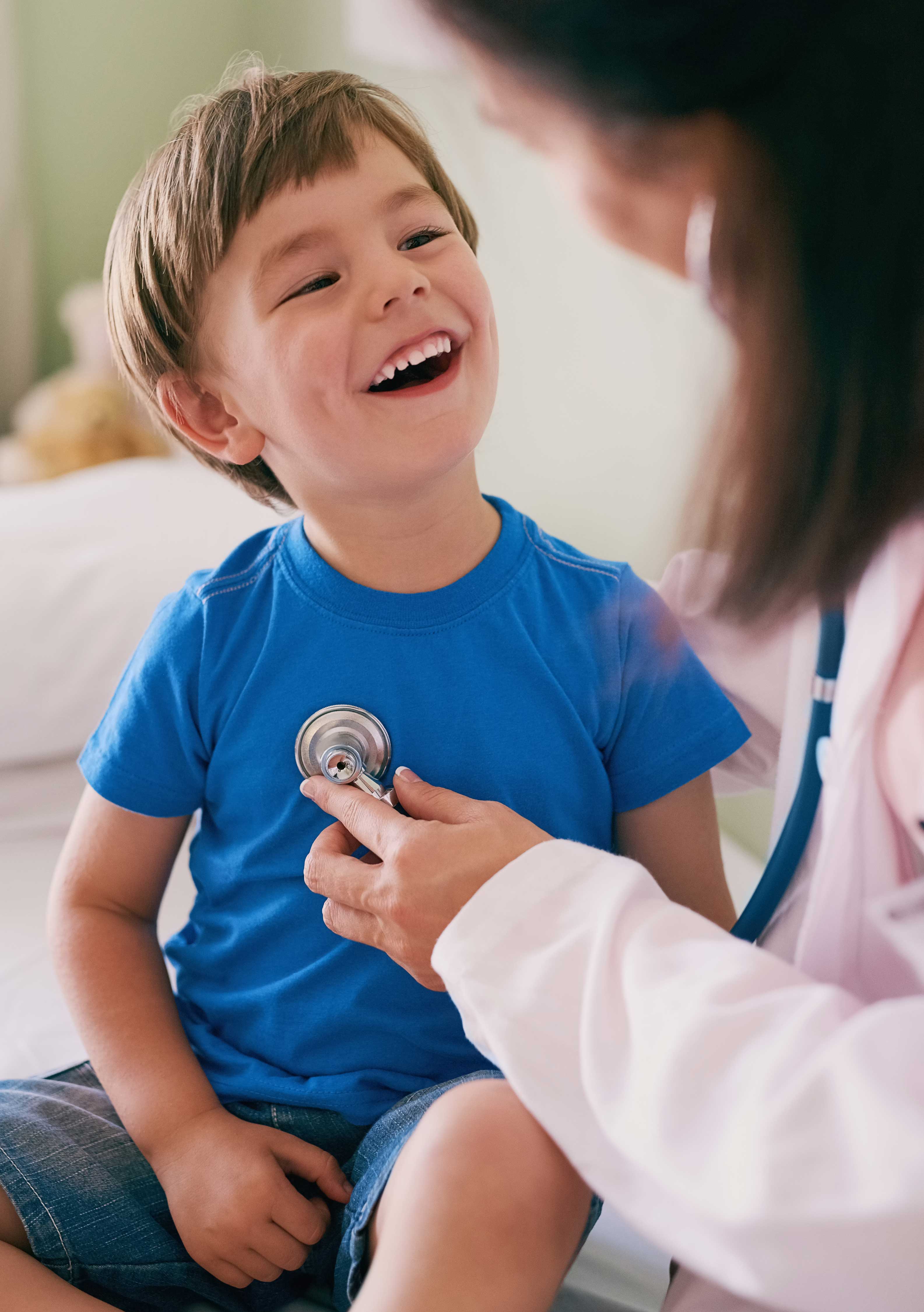 Doctor examining pediatric patient's heart with a stethoscope